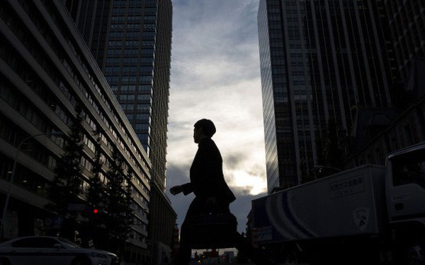 a-commuter-is-silhouetted-in-tokyo-157000676167041