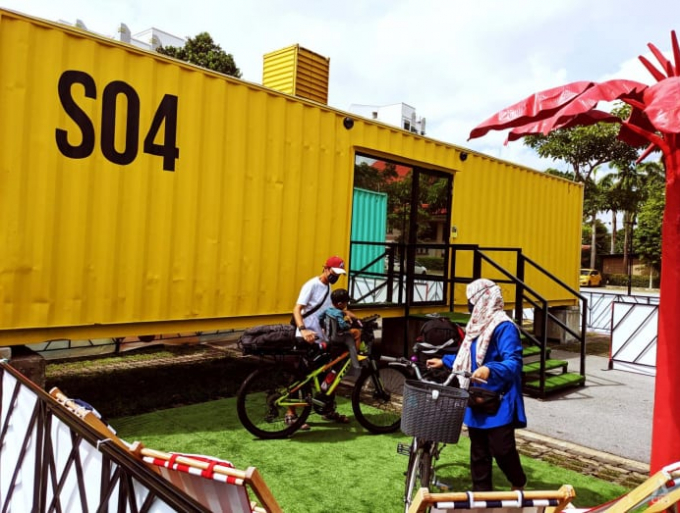 a-family-on-bicycles-outside-their-room-sg-hotel-o